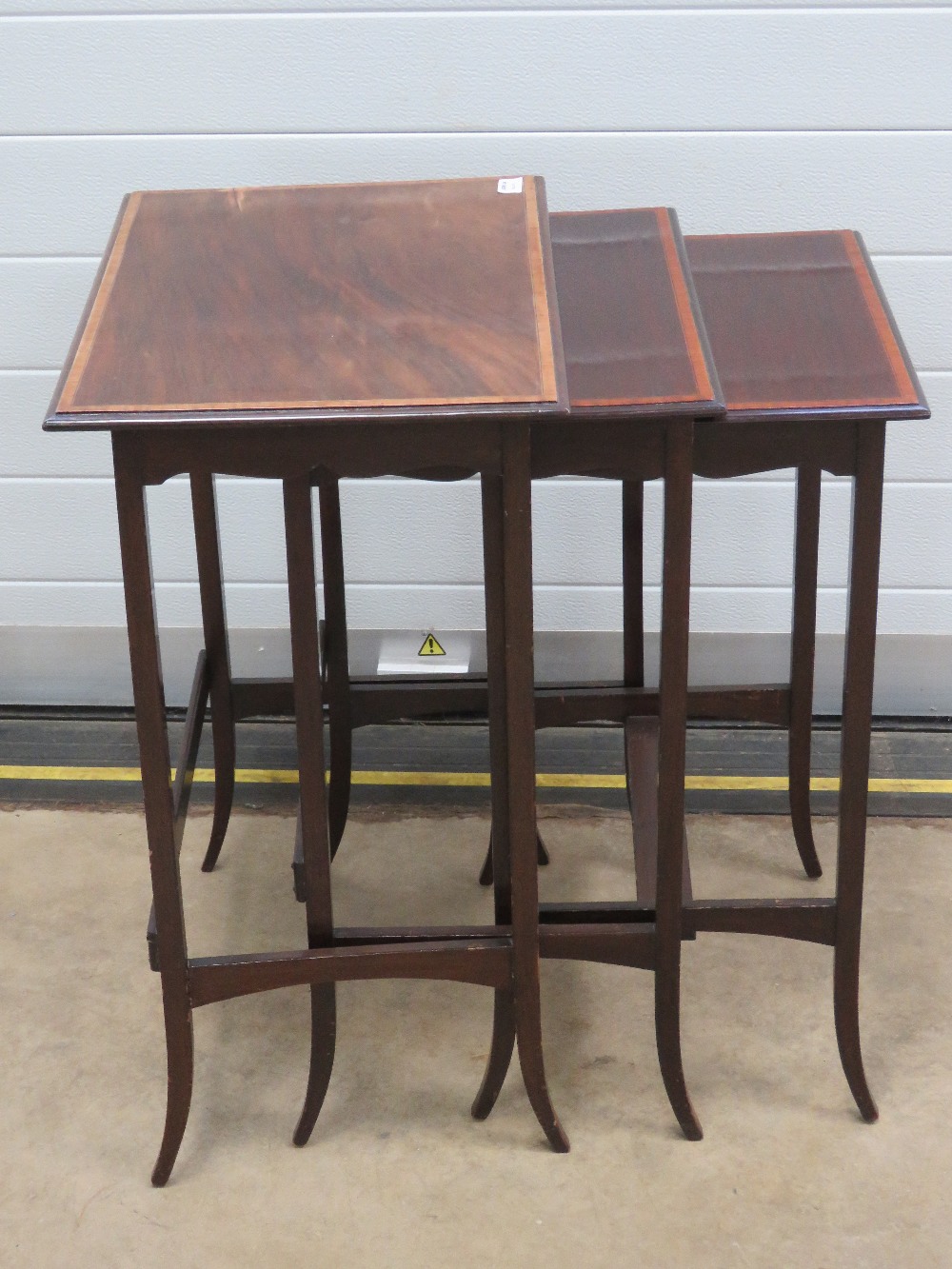 A good Edwardian nest of three mahogany tables each crossbanded with walnut and raised over slender - Image 2 of 3
