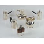 A pair of opposing silver plated hot chocolate pots with ebonised handles,