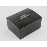 A Breitling black bakelite watch box, contents deficient, 17 x 13.5 x 9.5cm.