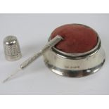 A silver pin cushion hallmarked Birmingham 1919, together with a HM silver pick, and a HG&S thimble.