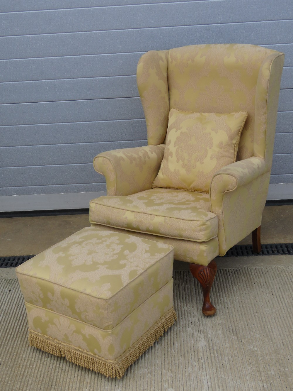 A single re-covered upholstered wingback chair in smart golden fabric with matching cushion and