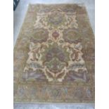 A good heavy woollen and silk rug in muted greens and browns measuring 238 x 154cm.