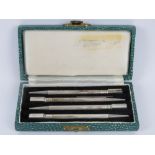 A delightful set of four Sterling silver bridge pencils in original presentation box, English made.