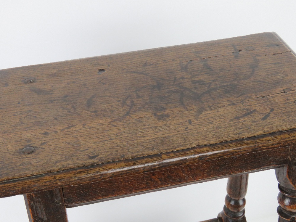 A good late 18th century oak joint stool raised over turned legs, united by pegged stretchers, - Image 2 of 3