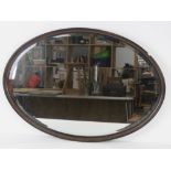 A good oval bevel edged rosewood framed over mantle mirror 80 x 56cm.