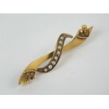 A 9ct gold late 19th / early 20th century bar brooch having ribbon design set with seed pearls,