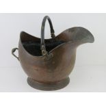 A large copper coal scuttle with swing handle over approx 45cm high.