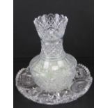 A lead crystal heavy cut glass two sectional lily vase, containing a quantity of glass beads,