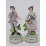 A pair of Continental Dresden type street seller figurines, each standing 19cm high,