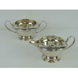 An HM silver sugar bowl and cream jug each raised over single foot and hallmarked Sheffield 1933