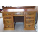 An early 20th century light mahogany kneehole writing desk, plain leather inset surface,
