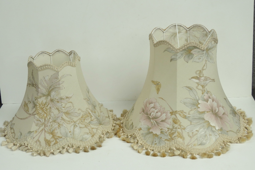 A graduated pair of floral pattern lamp shades being 43cm dia and 38cm dia respectively.