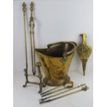 A brass coal bucket together with a quantity of fireside tools.