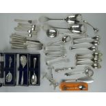 A quantity of assorted silver plated items inc knife rests, cake forks, butter knives, sugar tongs,
