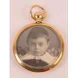 An Edwardian 9ct gold glazed locket having photograph to each side,