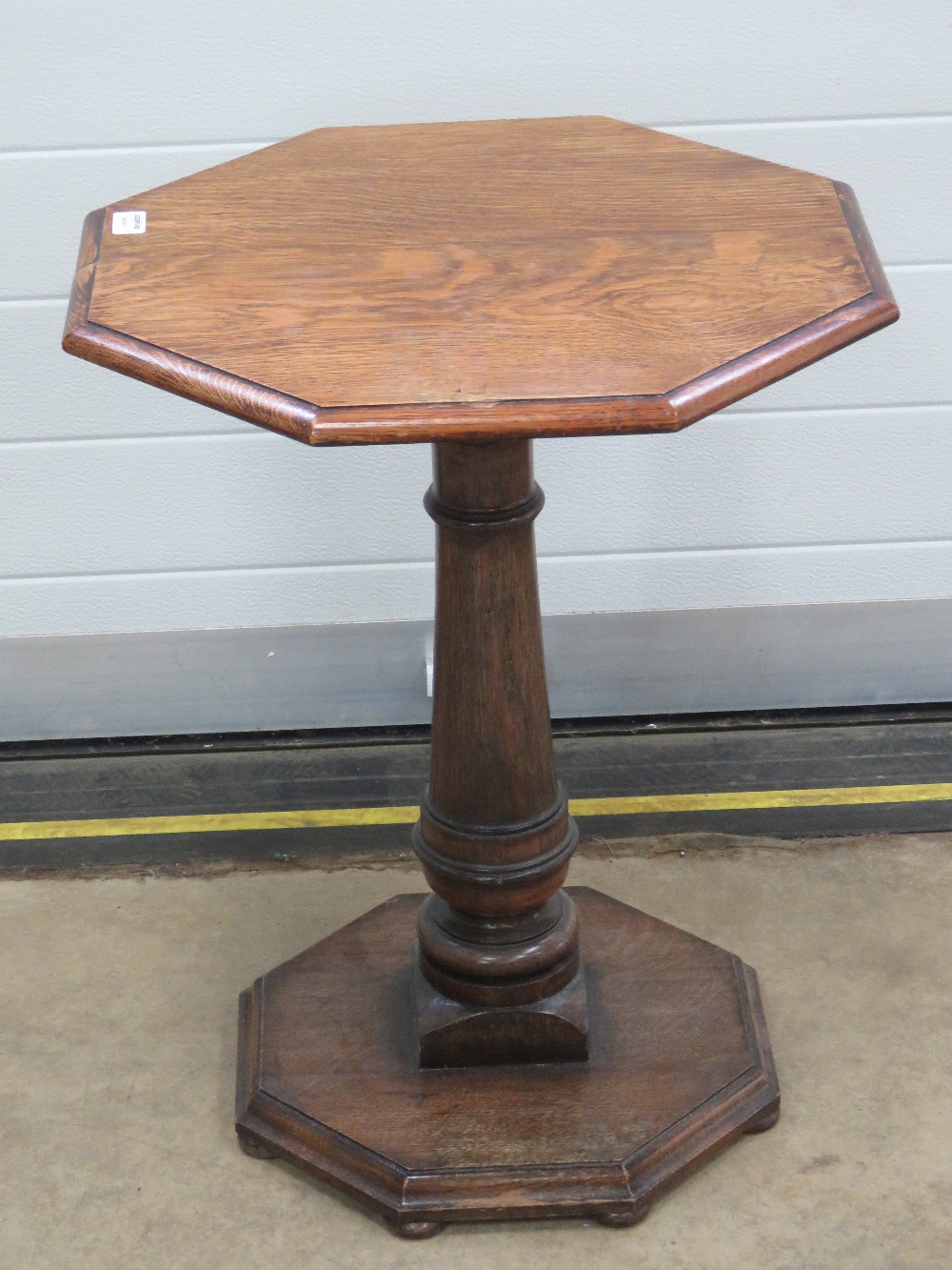 A good octagonal occasional side table in oak raised over gun barrel stem, 50 x 50 x 64cm.