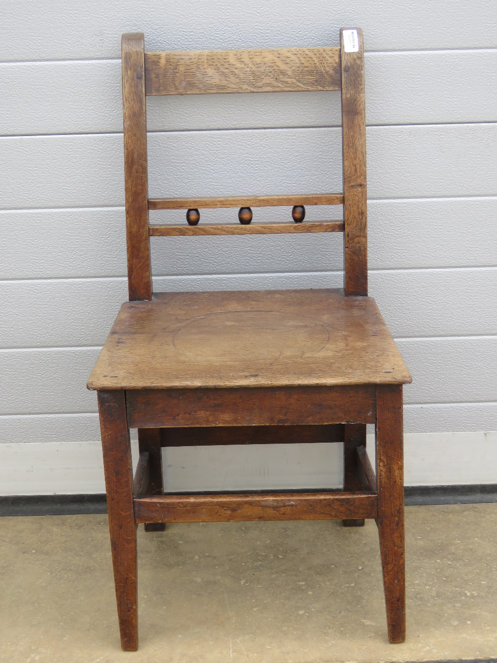 A single elm seated Oxford bar back chair.