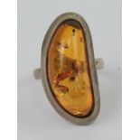 A silver and Baltic amber ring, 3cm wide, stamped 925, size P-Q.
