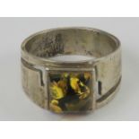 A silver an Baltic amber ring, the wide graduated band measuring 1.
