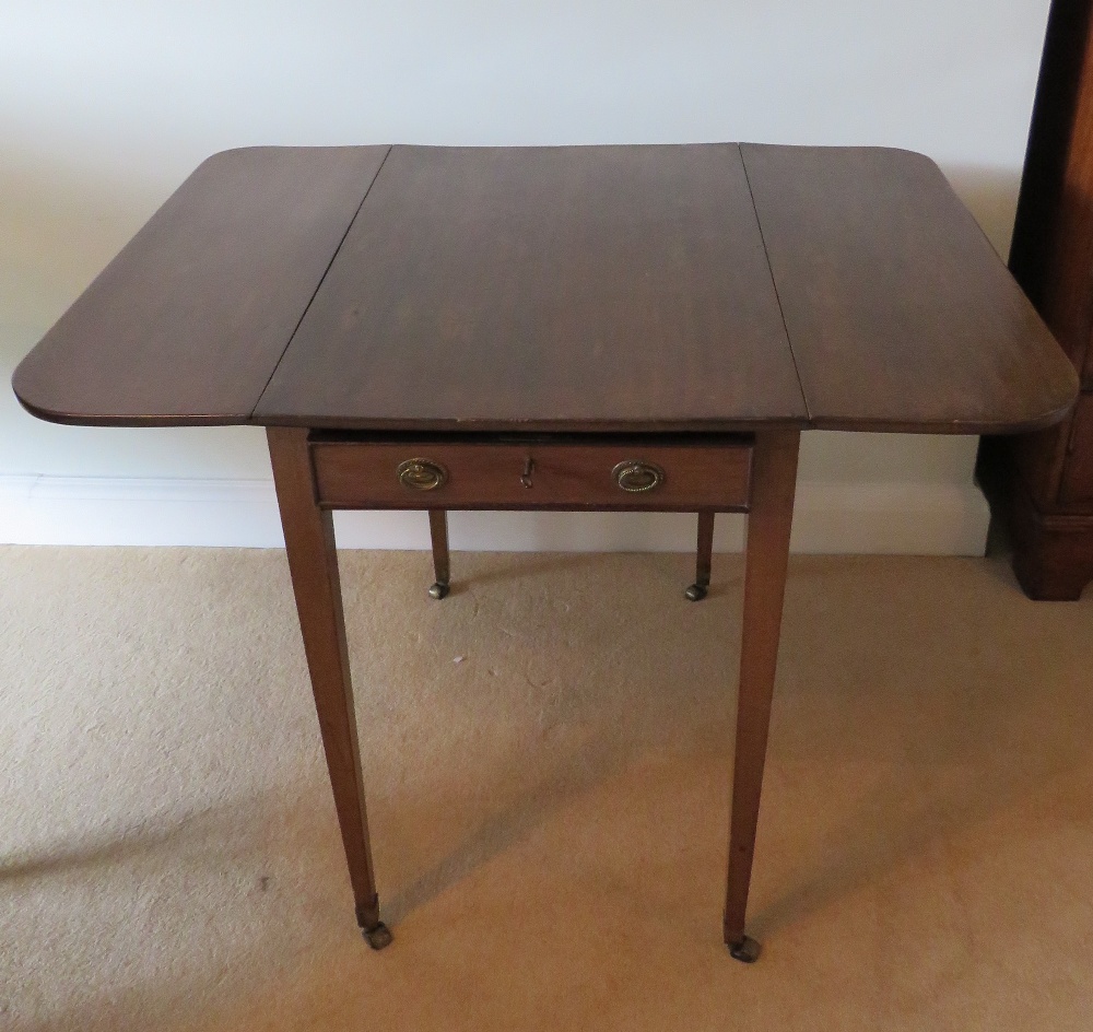 An Edwardian mahogany drop leaf table raised over square tapering legs terminating in roller - Image 2 of 3