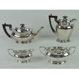 An Art Deco HM silver four piece tea service comprising tea pot and hot water pot each with