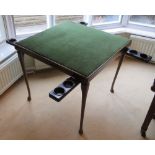 A patented folding leg games table having hinged bakelite guinea trays each with integral smokers