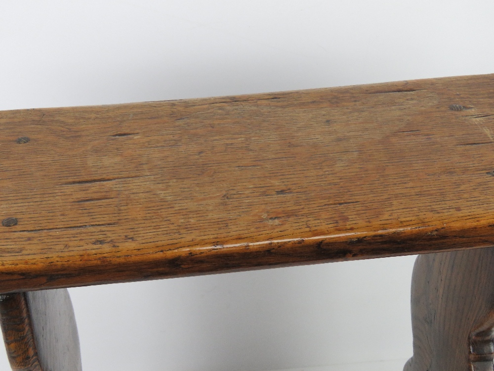 An early 20th century joint stool in oak, plank top and supports united by shaped trestle stretcher, - Image 2 of 3