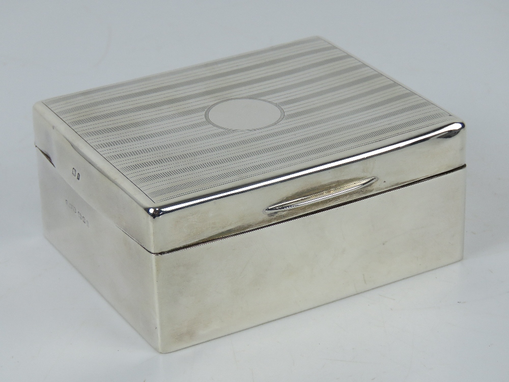 An HM silver cigarette box having engraved pattern to lid,