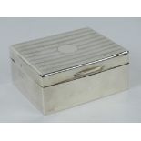 An HM silver cigarette box having engraved pattern to lid,