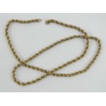 A yellow metal chain necklace, clasp deficient, no apparent hallmarks, untested, 49cm in length,