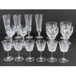 A set of six cut glass aperitif glasses together with four cut glass champagne flutes,