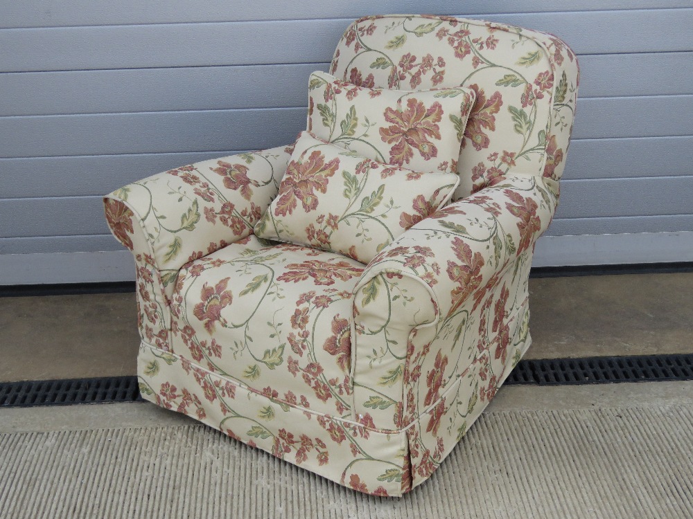 A good recovered oversprung arm chair of classic proportions bearing attractive floral moquet,