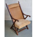 An Edwardian mahogany framed library chair having chamfered decoration throughout,