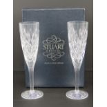 A pair of Stuart Crystal champagne flutes having original label on box.