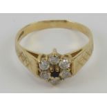 A 9ct gold ring having sapphire and cz floral cluster, hallmarked 375, size O, 2.3g.