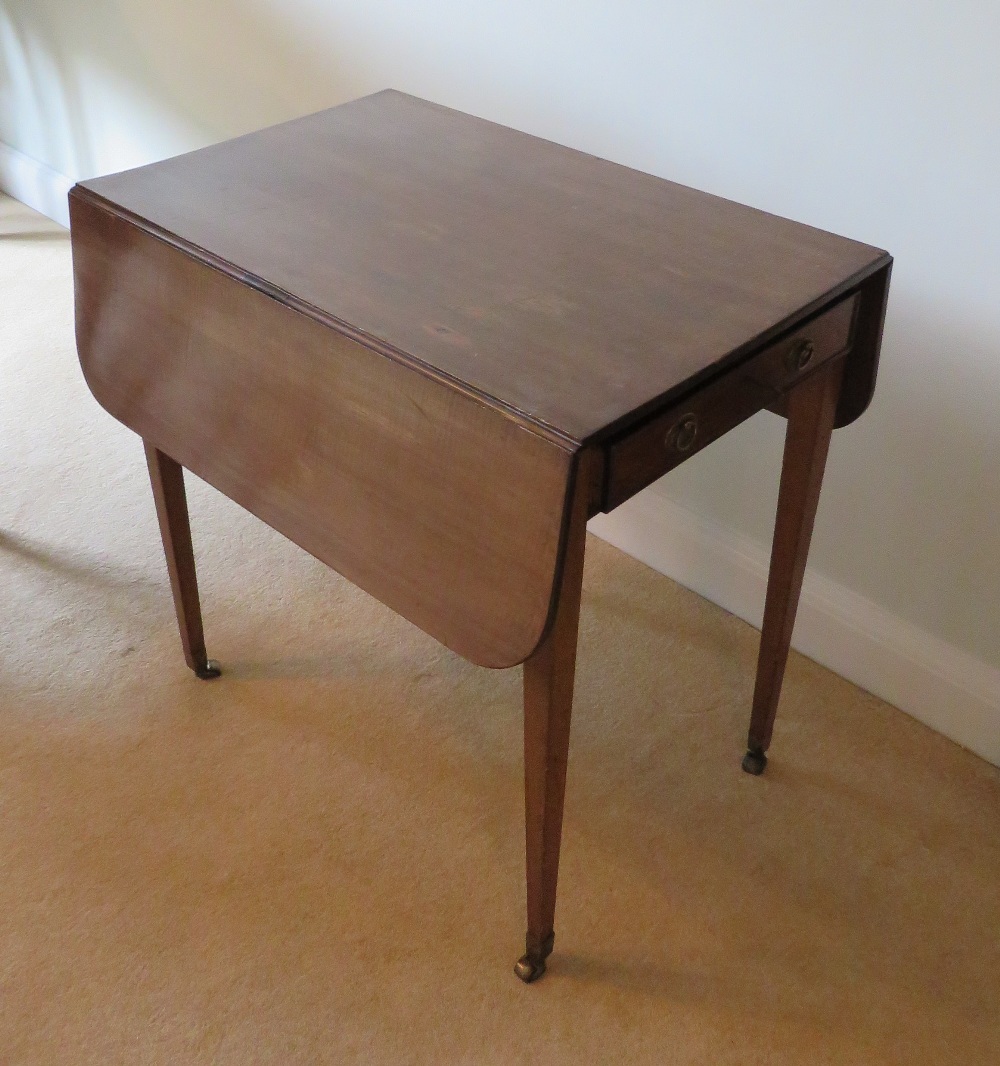 An Edwardian mahogany drop leaf table raised over square tapering legs terminating in roller - Image 3 of 3