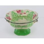 A Royal Doulton pedestal bowl having octagonal fluted twin handled bowl raised over single foot,