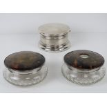 An HM silver dressing table powder pot having hinged lid opening to reveal vintage powder puff