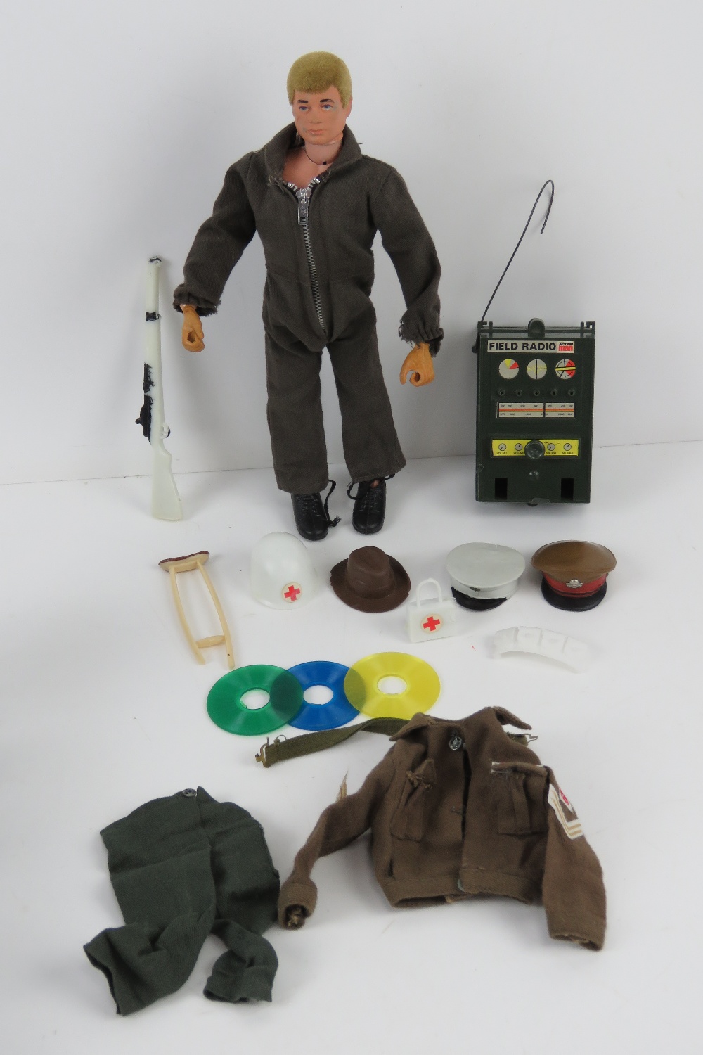 A vintage Action Man made by Palitoy with assorted accessories including; jacket, trousers, hats,