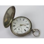 An HM silver full hunter key wind pocket watch, hallmarked London 1877, glass deficient,