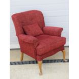 A vintage arm chair re-upholstered in contemporary red fabric, with cushion,