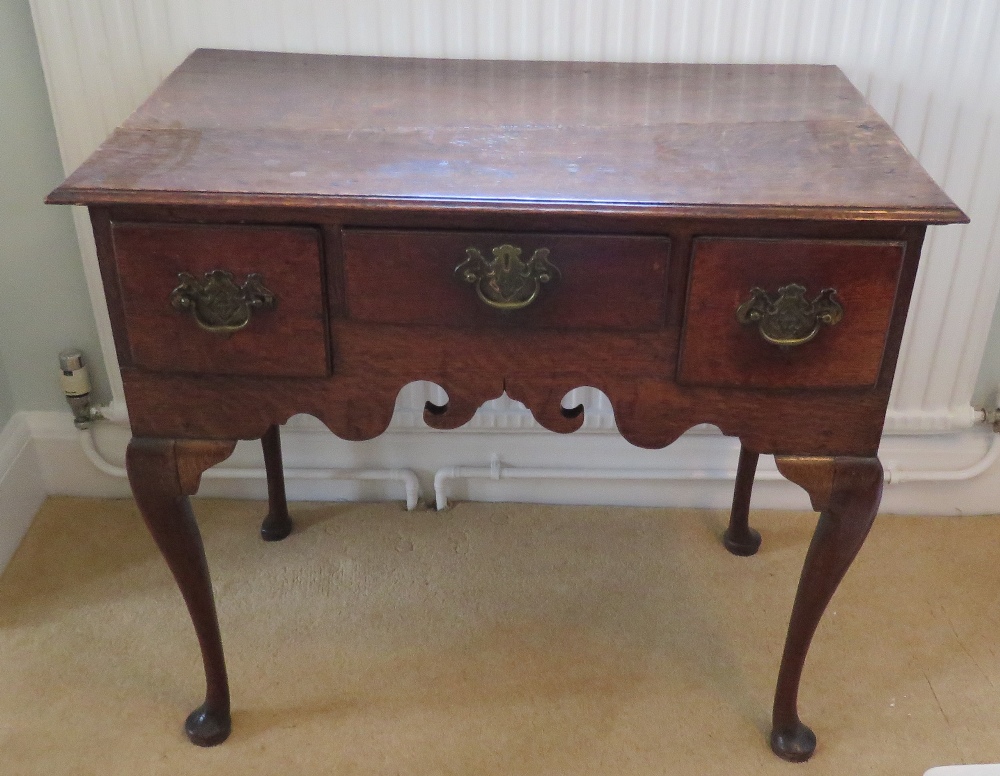 A Georgian low boy, central drawer flanked by twin box drawers,