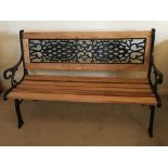 A West Sussex Oak and cast metal framed garden bench, treated with Osmo oil and finished in beeswax,