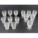 A quantity of matched cut glass footed tumblers, some round base, some octagonal,