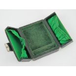 A leather covered velvet and silk lined travelling jewellery case, 8.5 x 11 x 4cm.