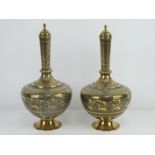 A good pair of decorative brass lidded baluster vases, 28cm high.