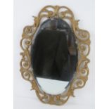 An oval bevelled edge wall mirror in gold painted frame 52 x 37cm.