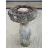 A two sectional stoneware bird bath.