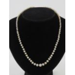 A strand of individually knotted pearls having diamond set clasp,