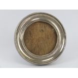 An HM silver circular photograph frame having wooden easel back, 9cm diameter,